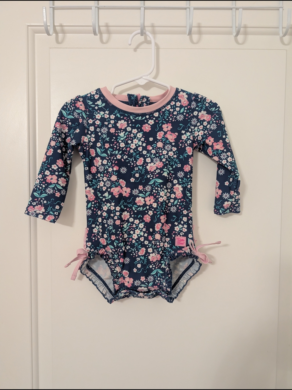 Ruffle Butts Navy Floral Rashguard One Piece with Pink Ruffle Trim